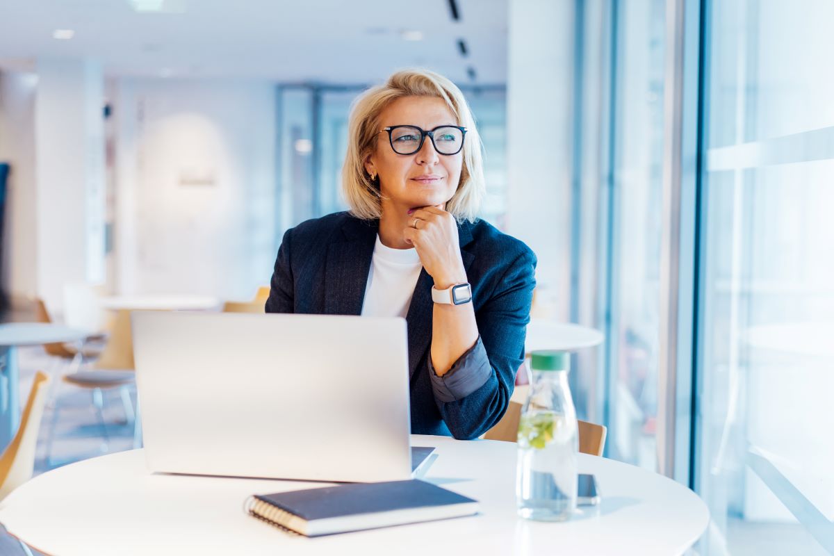 Woman looking at a window of her office