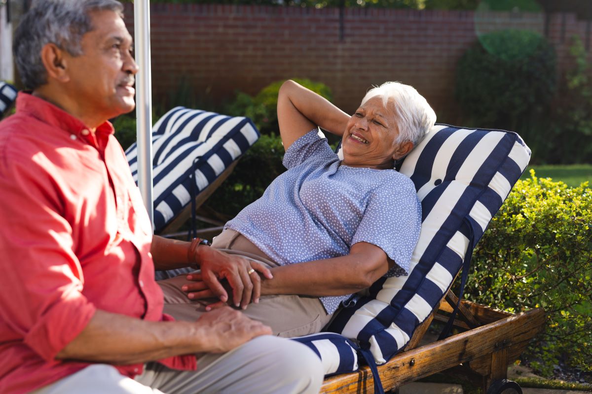 Retired couple resting in a hammock